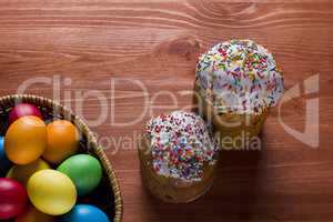 Easter eggs of different colors and cakes