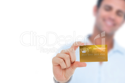 Happy businessman showing a credit card