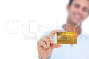Happy businessman showing a credit card