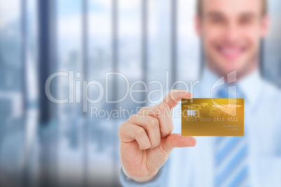 Composite image of happy businessman showing a creditcard