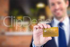 Composite image of happy businessman showing a creditcard