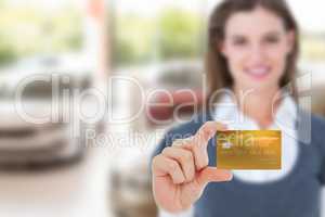 Composite image of happy businesswoman showing a creditcard