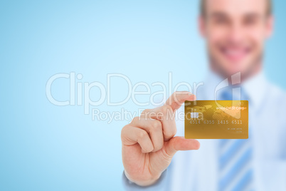 Composite image of happy businessman showing a creditcard