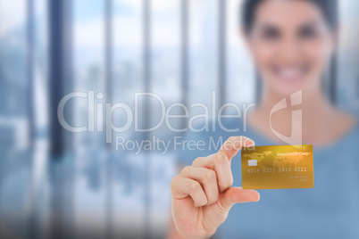 Composite image of happy businesswoman showing a creditcard