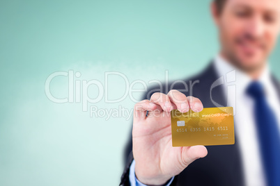 Composite image of businessman showing a creditcard Composite image of businessman showing a creditcard
