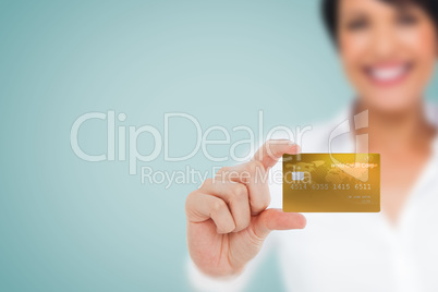 Composite image of happy businesswoman showing a creditcard