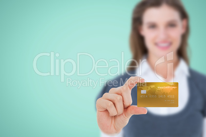 Composite image of happy businesswoman showing a creditcard