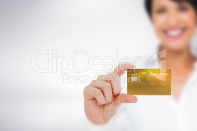 Composite image of happy businesswoman showing a creditcard