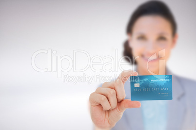 Composite image of happy businesswoman showing a creditcard Composite image of happy businesswoman showing a creditcard