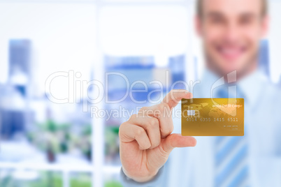 Happy businessman showing a creditcard