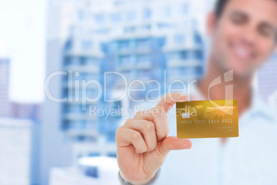 Happy businessman showing a credit card