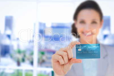 Happy businesswoman showing a creditcard