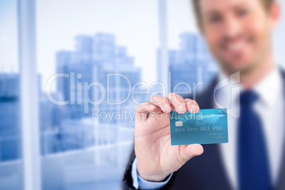 Happy businessman showing a creditcard