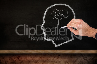 Composite image of hand of a businessman writing with a white chalk