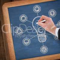 Composite image of hand of businessman writing with a white chalk