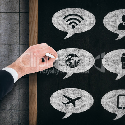 Composite image of hand of businessman writing with a white chalk