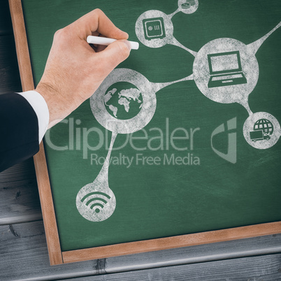 Composite image of hand of businessman writing with a white chalk