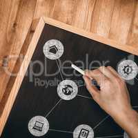 Composite image of hand writing with chalk