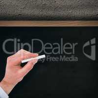 Composite image of businessman writing with white chalk