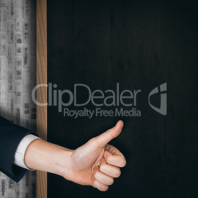 Composite image of hand showing thumbs up