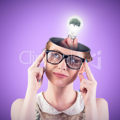 Composite image of hand holding environmental light bulb