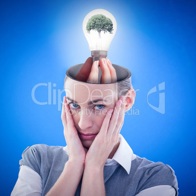 Composite image of hand holding environmental light bulb