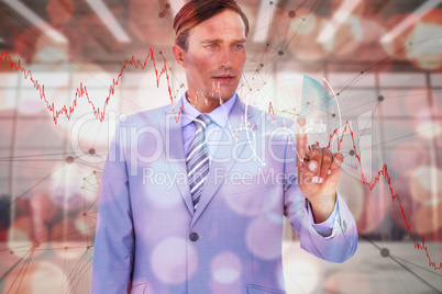Composite image of handsome businessman touching invisible screen