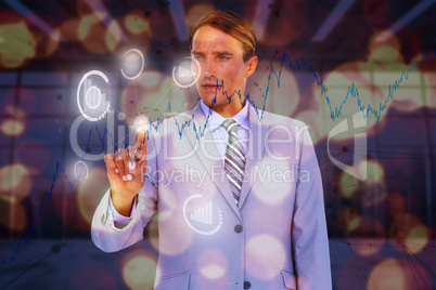 Composite image of handsome businessman touching invisible screen