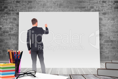 Composite image of business man writing with chalk