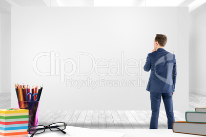 Composite image of wear view of businessman thinking