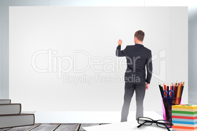 Composite image of business man writing with chalk