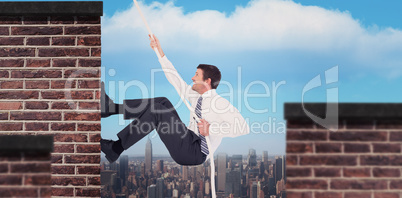 Composite image of businessman pulling a rope