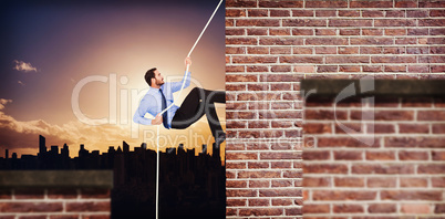 Composite image of businessman pulling a rope with effort