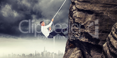 Composite image of businessman pulling rope while sitting on cube