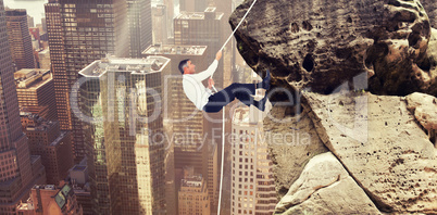 Composite image of businessman pulling rope while sitting on cube