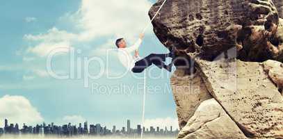 Composite image of businessman pulling rope while sitting on cube