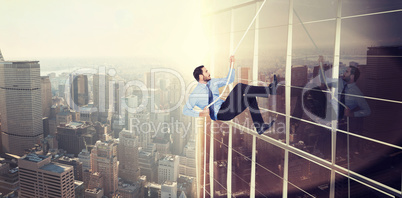 Composite image of businessman pulling a rope with effort