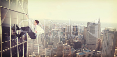 Composite image of businessman pulling a rope