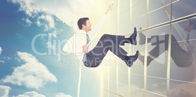 Composite image of businessman pulling a rope