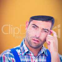 Composite image of portrait of confused manual worker scratching head