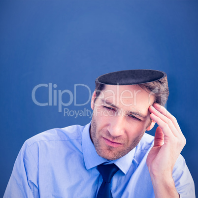 Composite image of stressed businessman holding his head