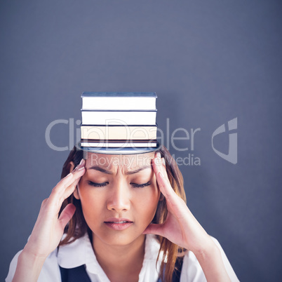 Composite image of nervous businesswoman holding her head
