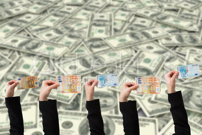 Composite image of businesswomans hand holding fifty euro notes