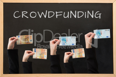 Composite image of businesswomans hand holding fifty euro notes