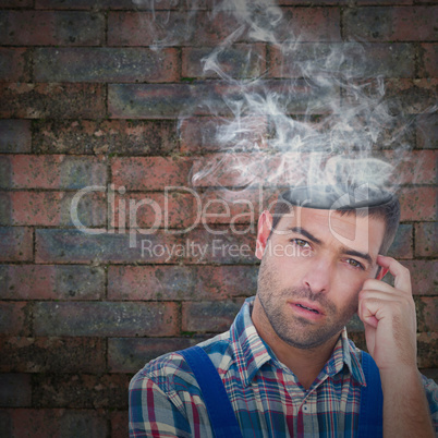 Composite image of portrait of confused manual worker scratching head