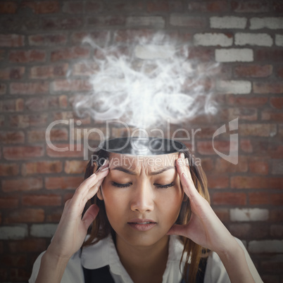 Composite image of nervous businesswoman holding her head