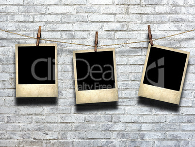 photo on rope with clothespins on a background of a brick wall