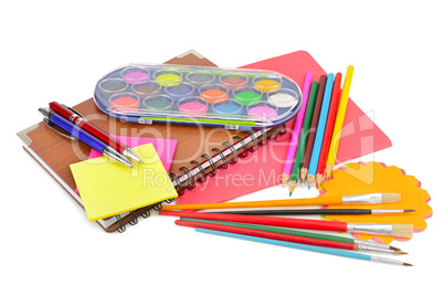 colored pencils, paints, notebooks and other stationery isolated