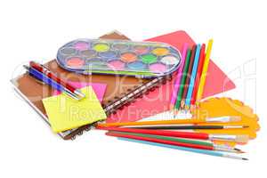colored pencils, paints, notebooks and other stationery isolated