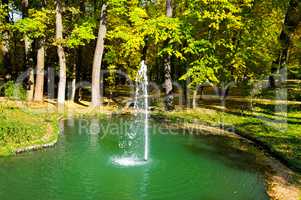 autumn park, a pond and a small fountain